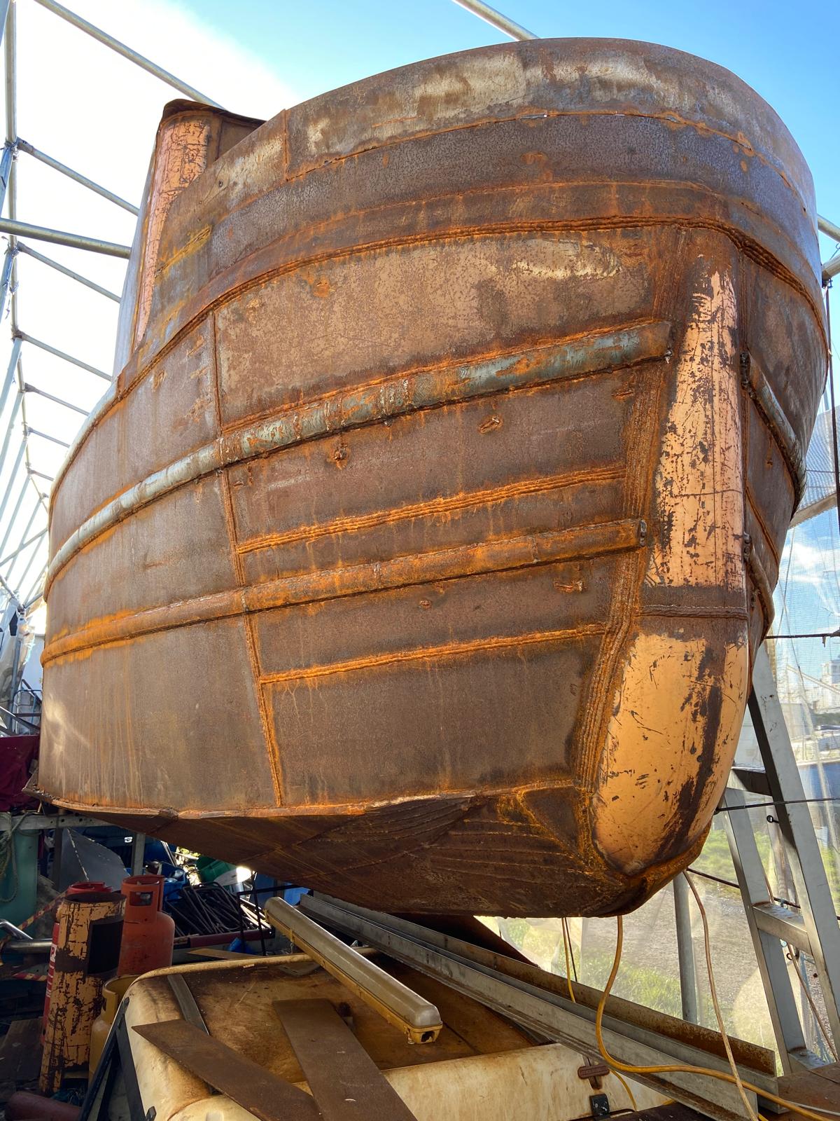 Steel narrowboat bow plates welded up in build cradle